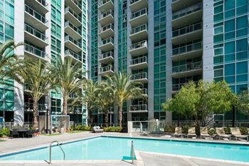 a large swimming pool in front of an apartment building at Vue, San Pedro, CA